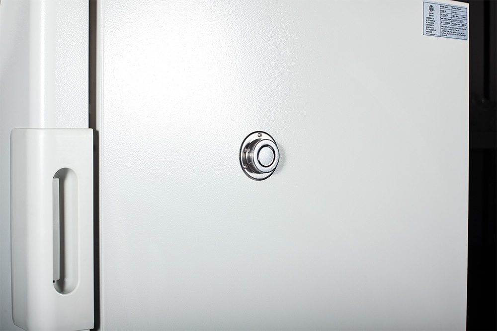 Close-up of the incubator's door latch and closed access port